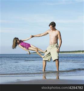 Father and daughter playing on beach