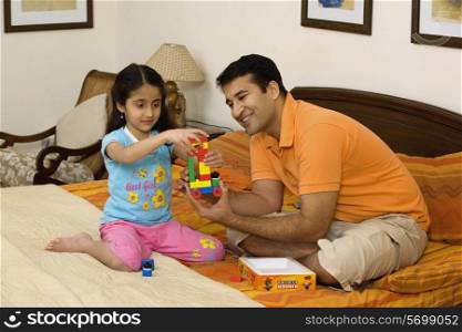 Father and daughter playing with toys