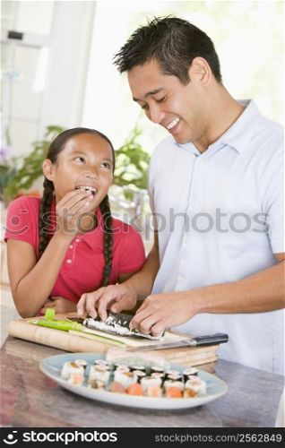 Father And Daughter Preparing Sushi Together