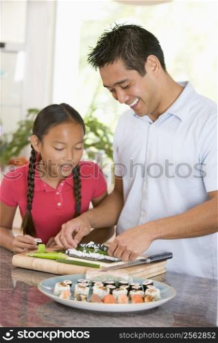 Father And Daughter Preparing Sushi Together