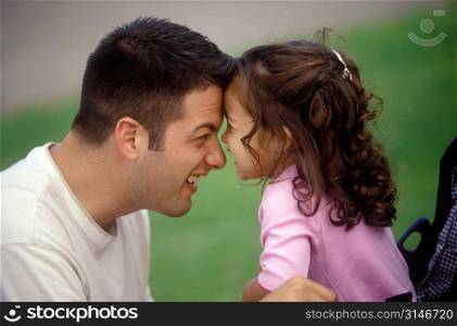 Father And Daughter Putting Their Heads Together And Laughing