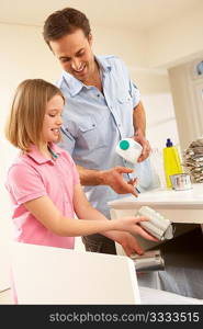 Father And Daughter Recyling Waste At Home