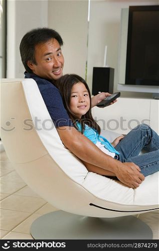 Father and Daughter Relaxing in Living Room