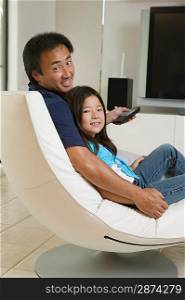 Father and Daughter Relaxing in Living Room