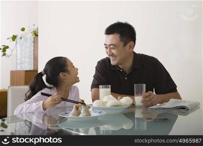 Father and daughter sat at a table