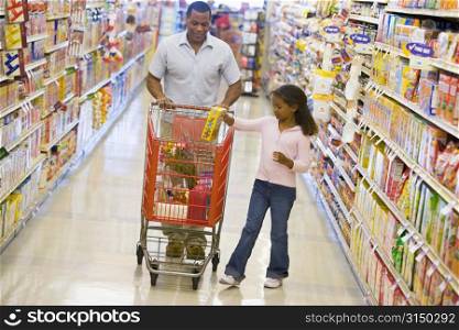 Father and daughter shopping at a grocery store