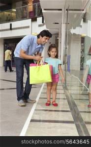 Father and daughter shopping together in mall