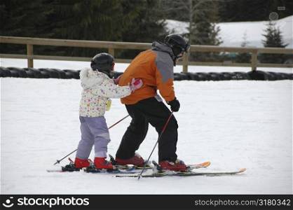 Father and daughter skiing