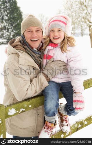 Father And Daughter Standing Outside In Snowy Landscape
