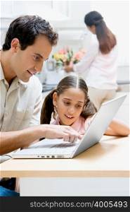 Father and daughter using a laptop computer