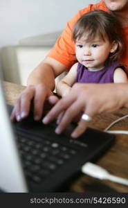 Father and daughter using computer