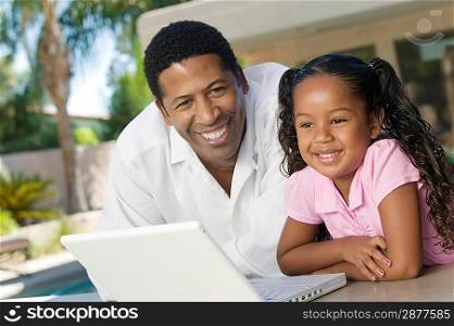 Father and Daughter Using Laptop
