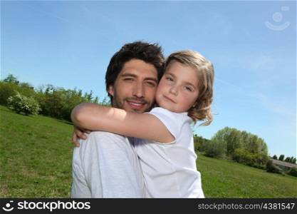 Father and daughter walking in a field together