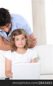 Father and daughter with a laptop