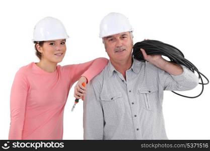 Father and daughter with electrical cable