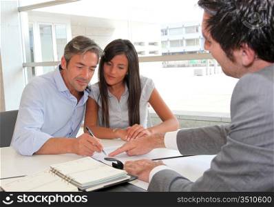 Father and girl signing loan contract