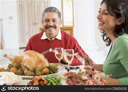 Father And His Adult Daughter Sitting Down For Christmas Dinner