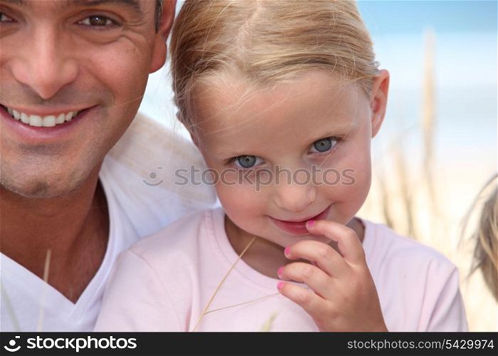 Father and his daughter on beach.