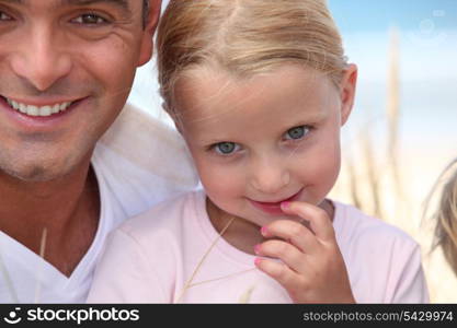 Father and his daughter on beach.