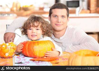 father and his little boy making a pumpkin pie