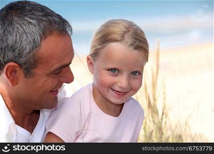 father and his little girl on the daughter beach