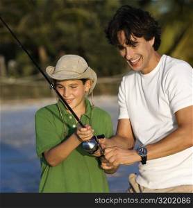 Father and his son fishing on the beach