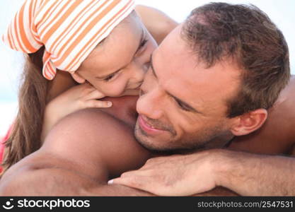 father and kid having fun on the beach