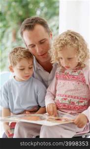 Father and kids reading
