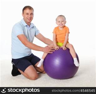 father and little daughter doing sport together