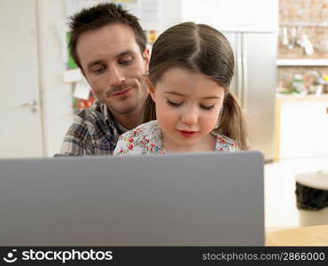 Father and Little Girl Using Laptop Together