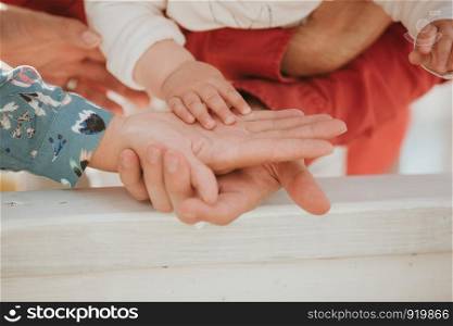 father and mother hold in their hands a little baby's.. Mom and Dad hold baby's hand. Children's handle
