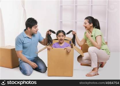 Father and mother holding daughters hair