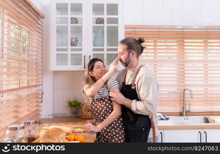 Father and mother in the house&rsquo;s kitchen have a good time making dinner together while awaiting the return of the youngster from school