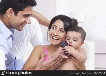 Father and mother playing with baby