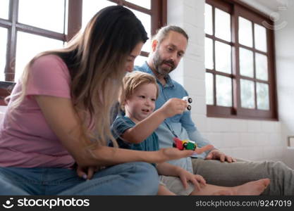 Father and mother with little boy have fun playing with your new toys in the bedroom together. Toys that enhance children&rsquo;s thinking skills.