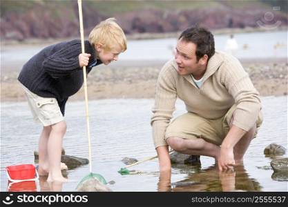 Father and son at beach fishing