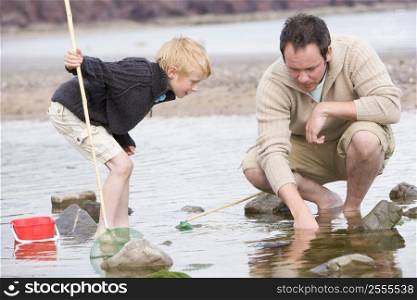 Father and son at beach fishing