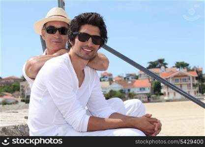 father and son at beach wearing sunglasses