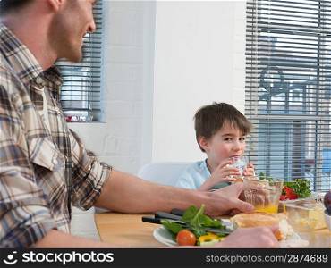 Father and Son at Dinner Table