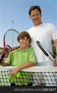Father and Son at Tennis Net