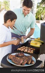 Father And Son Barbequing
