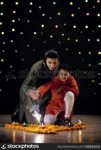 Father and son burning crackers