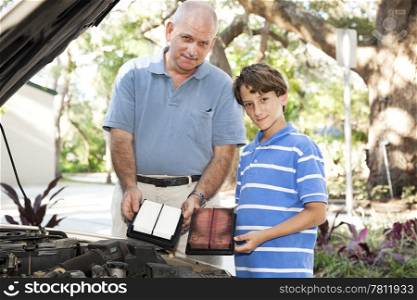 Father and son changing the air filter in the family car.