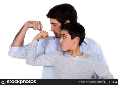 Father and son comparing their muscles