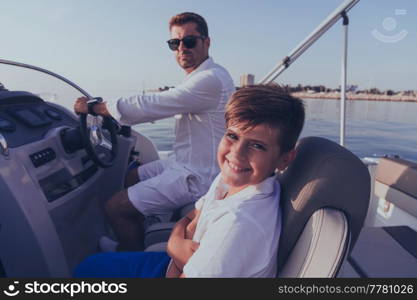 Father and son enjoy their vacation together while riding a luxury boat at sea. Selective focus. High-quality photo. Father and son enjoy their vacation together while riding a luxury boat at sea. Selective focus