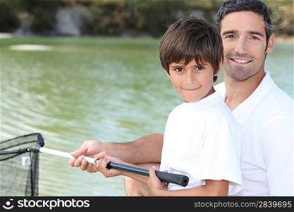 Father and son fishing on boat
