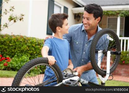 Father and son fixing bike