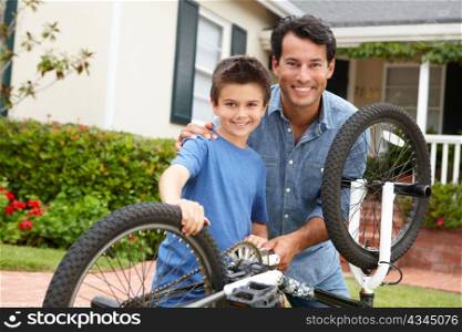Father and son fixing bike