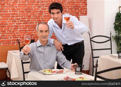 Father and son having dinner together