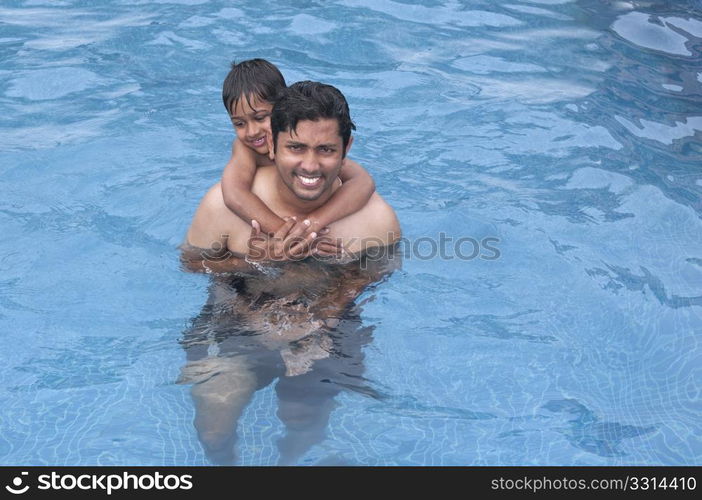 Father and Son having fun at the resport pool